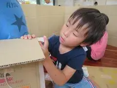 写真:集中してテープをはる子