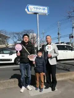 写真:やまゆり通りの看板と愛称採用者