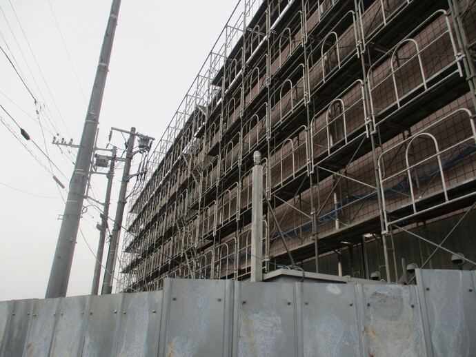 図書館の建物全体に組まれた足場と仮囲いの写真